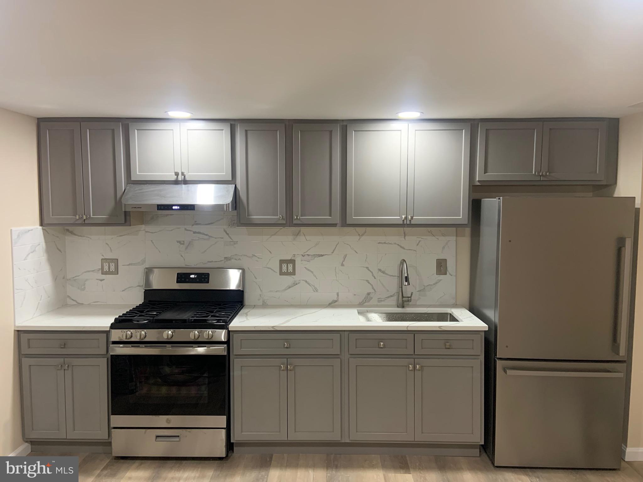 a kitchen with a sink and a refrigerator