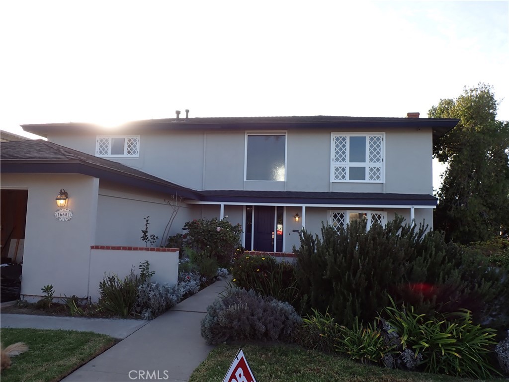 a front view of house along with green space