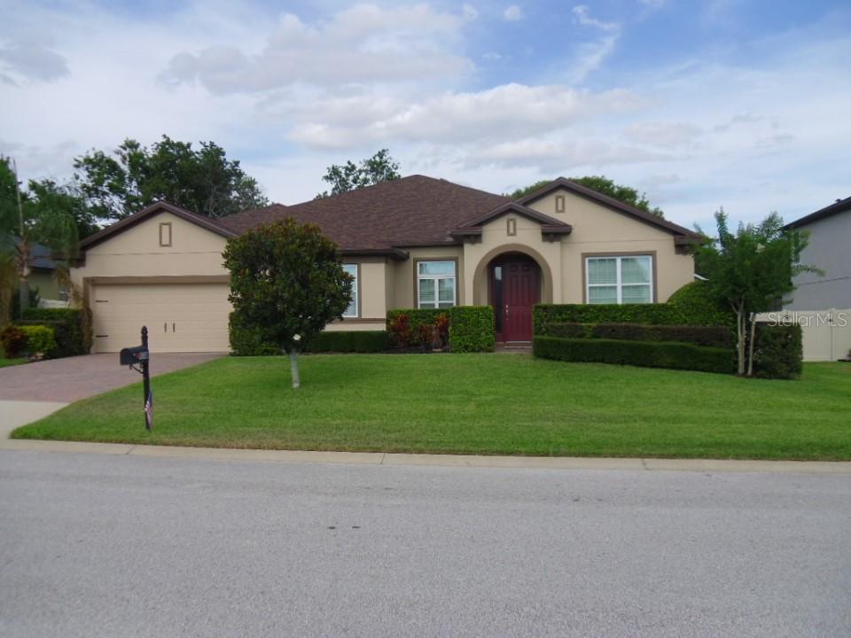 a front view of house with yard and green space