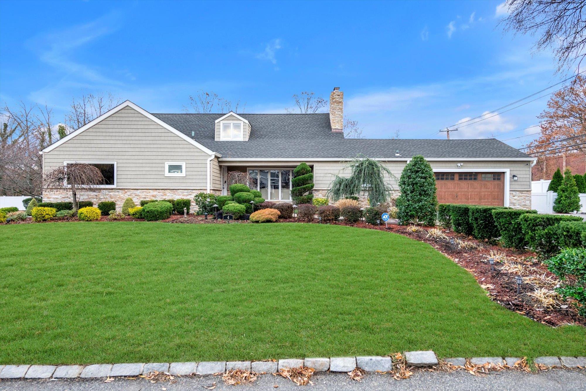 Colonial style house with a front yard and a garage