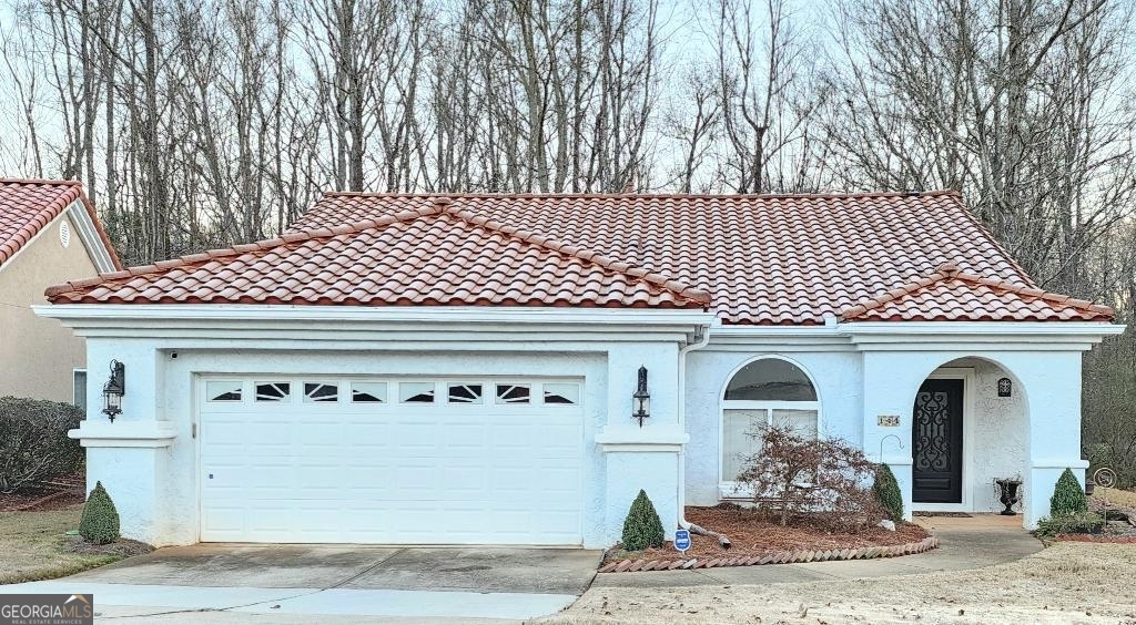 a front view of a house with plants