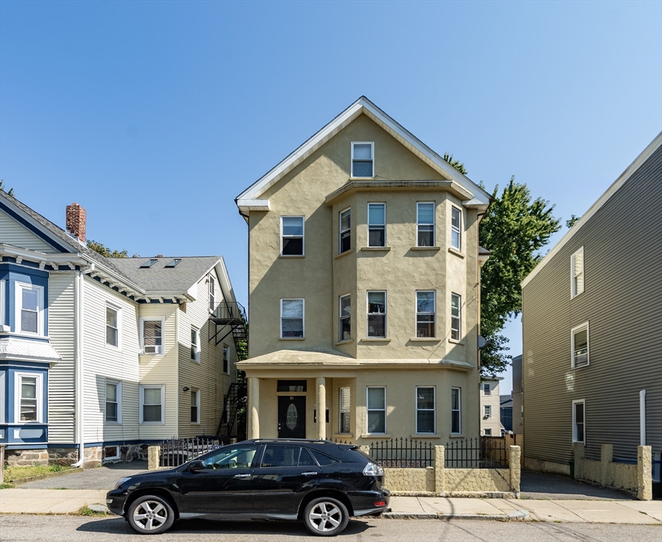 a front view of a residential apartment building with a yard