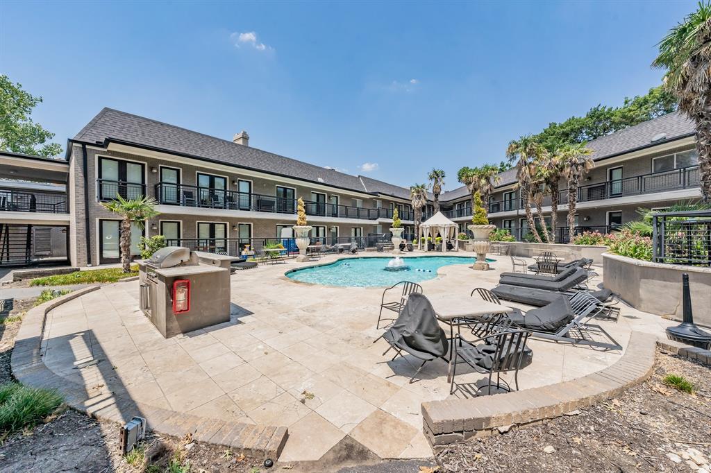 a view of swimming pool with outdoor seating