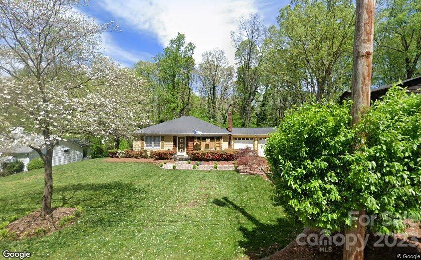 a view of a house with backyard sitting area and garden