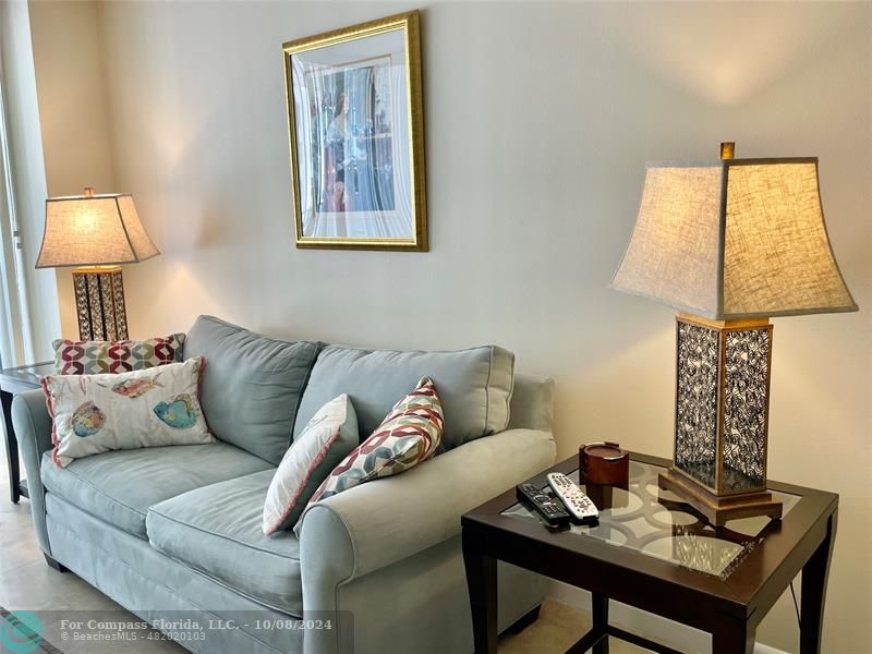 a living room with furniture and a lamp