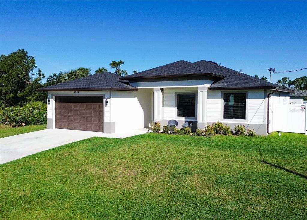 a front view of a house with a yard and garage