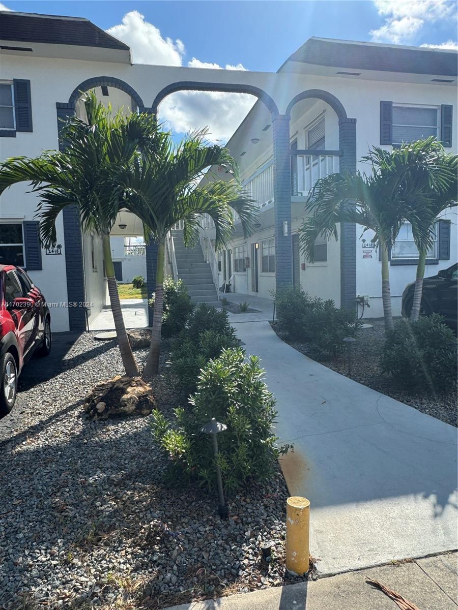 a couple of potted plants in front of building