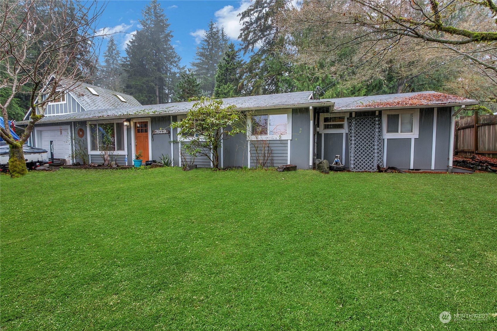 a view of a house with a yard and sitting area