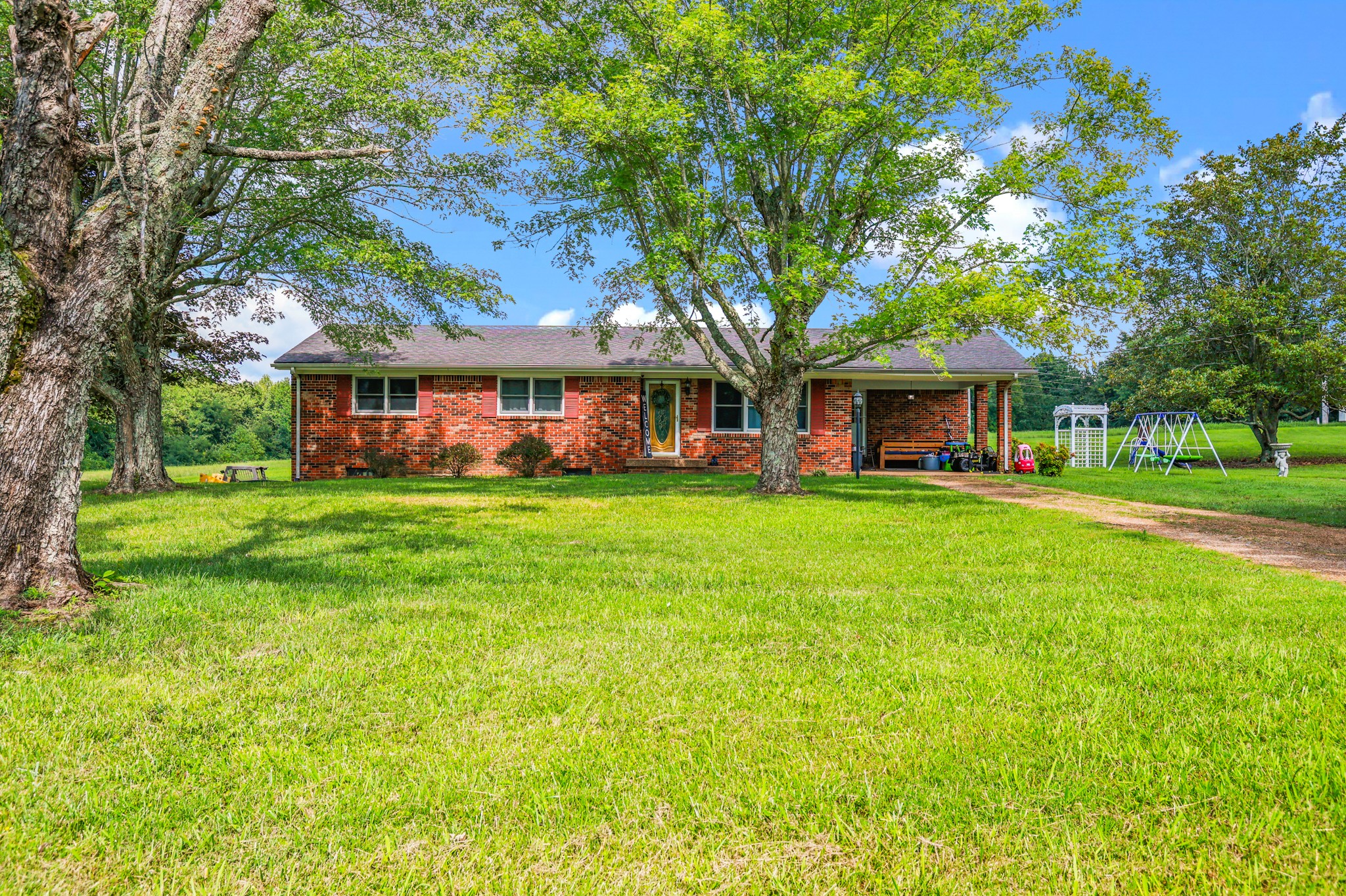 a view of house that has a yard