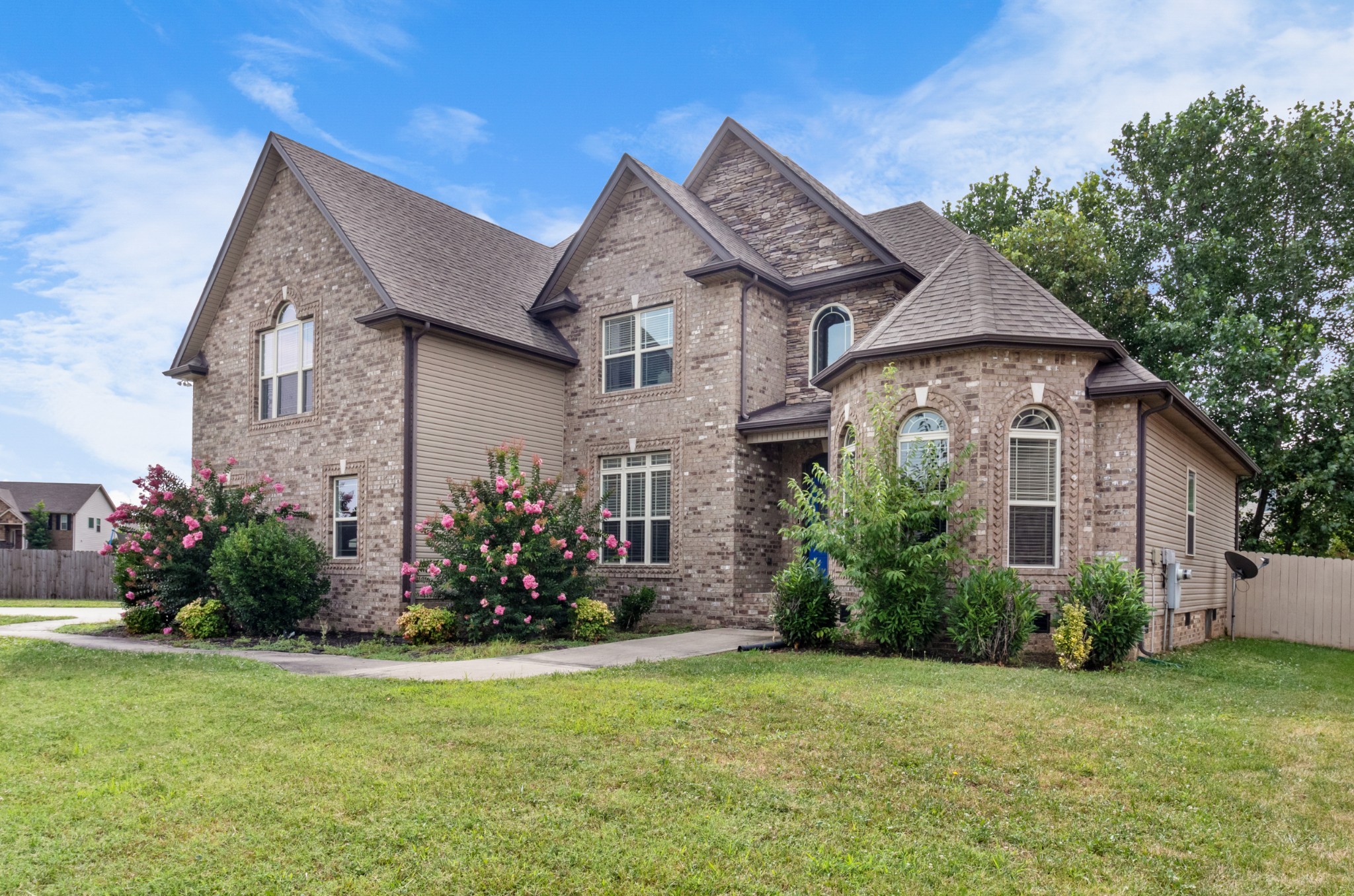 a front view of a house with a garden