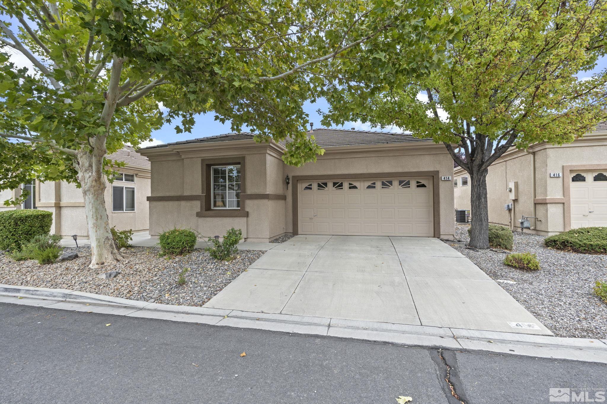 a front view of a house with garage and yard