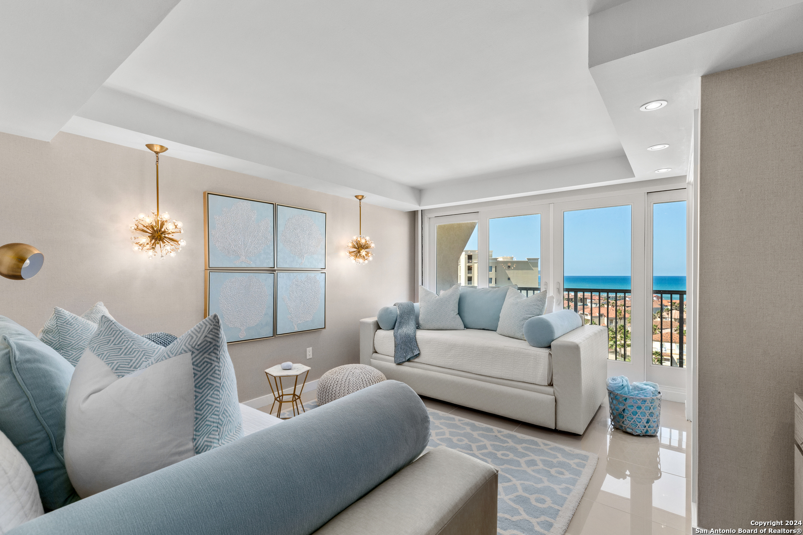 a living room with furniture and a chandelier