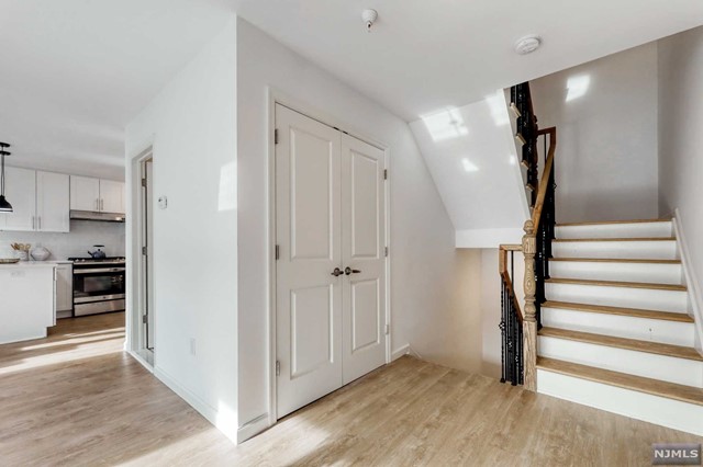 a view of a kitchen with a sink cabinets and entryway