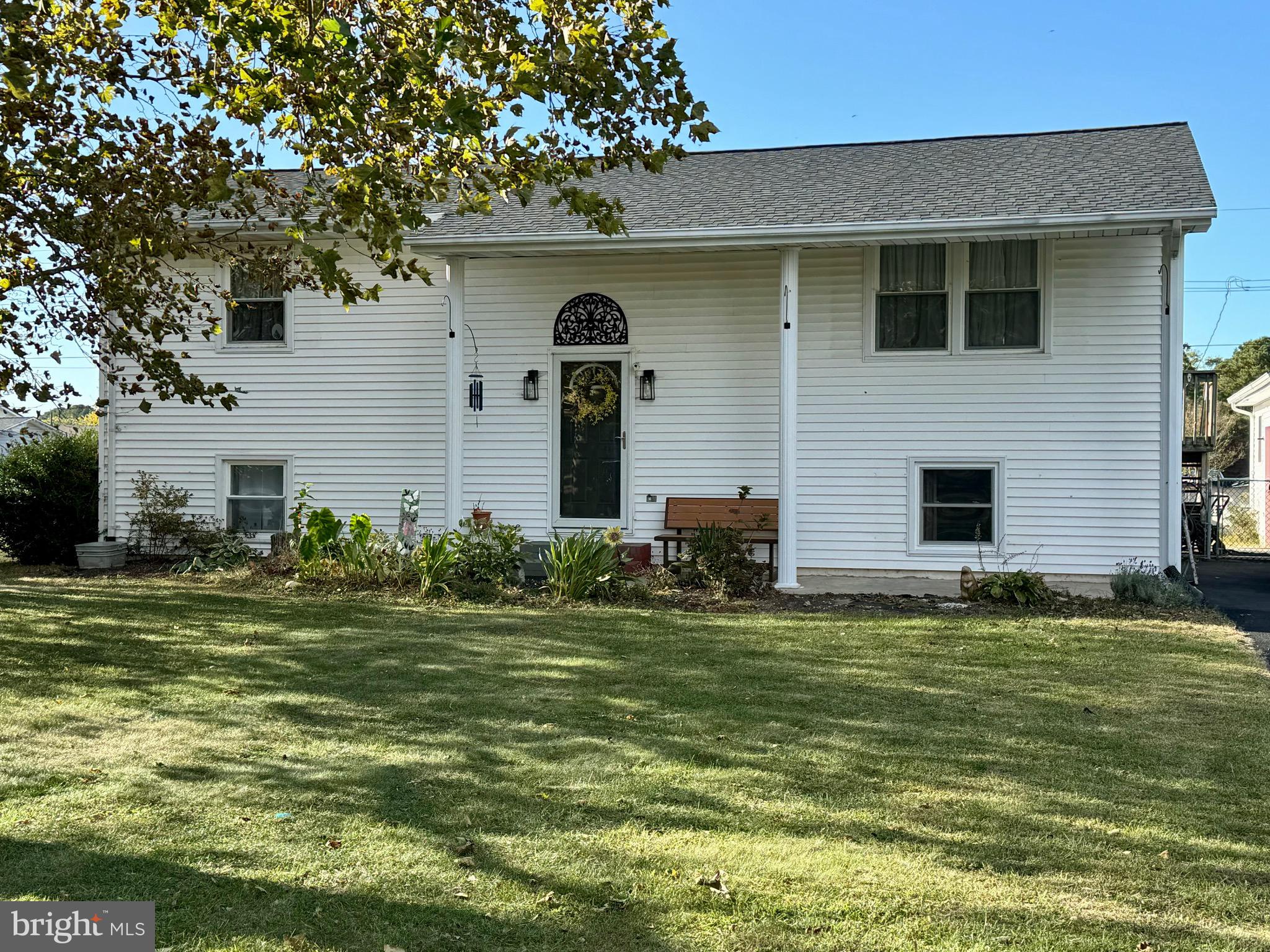 a front view of a house with a garden