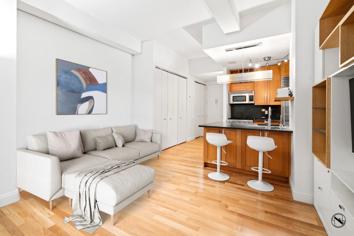 a living room with furniture a flat screen tv and a wall painting