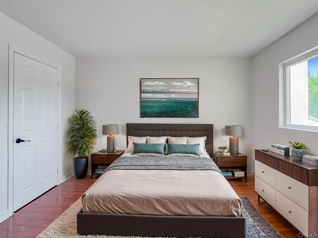 a bedroom with a bed and a potted plant