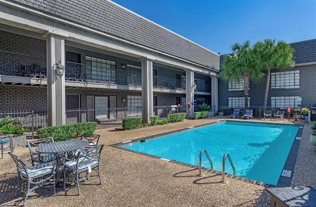 a view of a house with swimming pool and porch with furniture