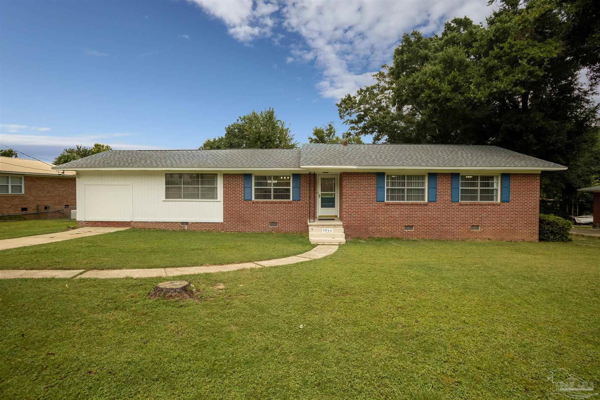 a view of a house with a backyard