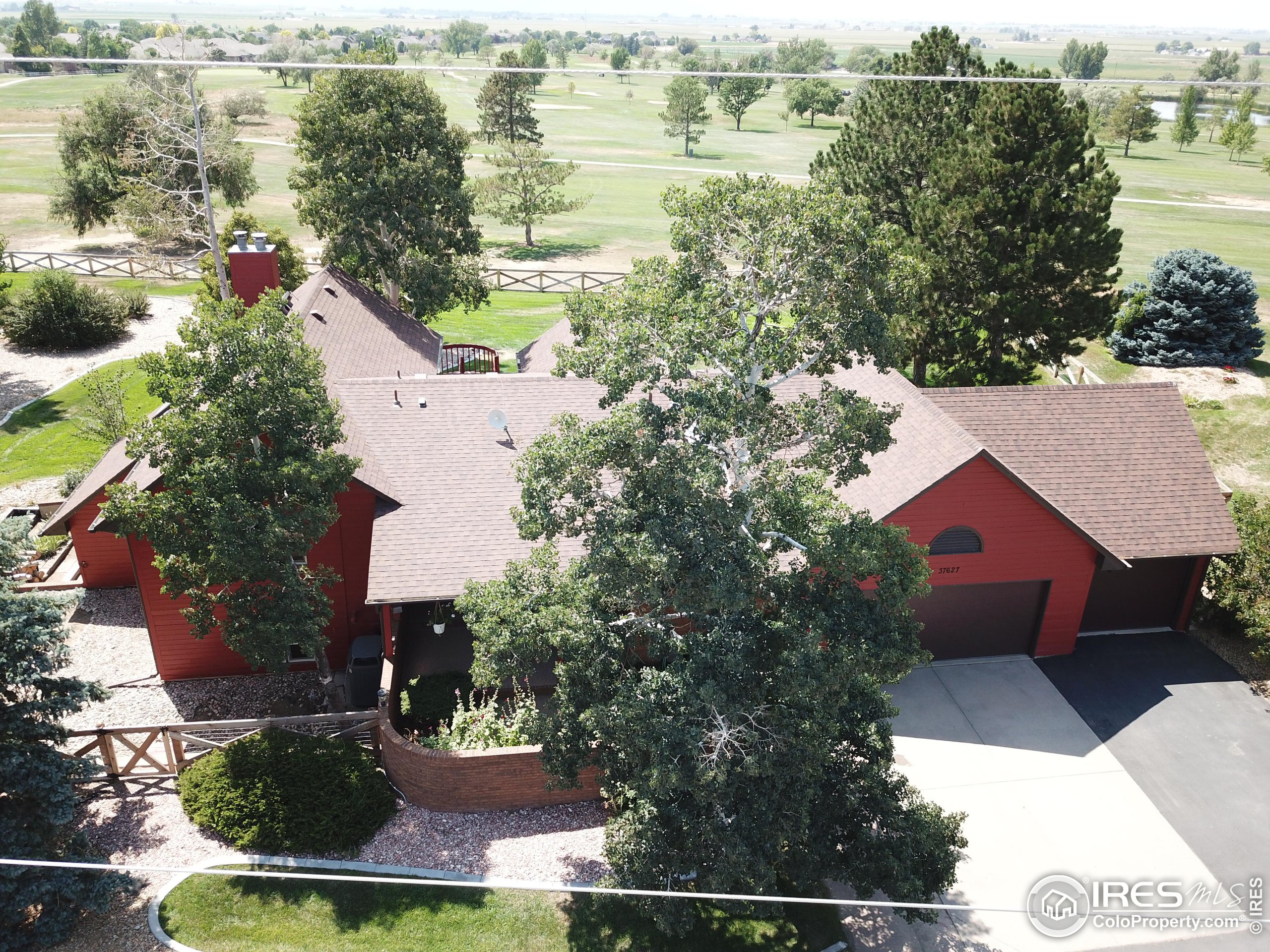 an aerial view of residential houses with outdoor space and river