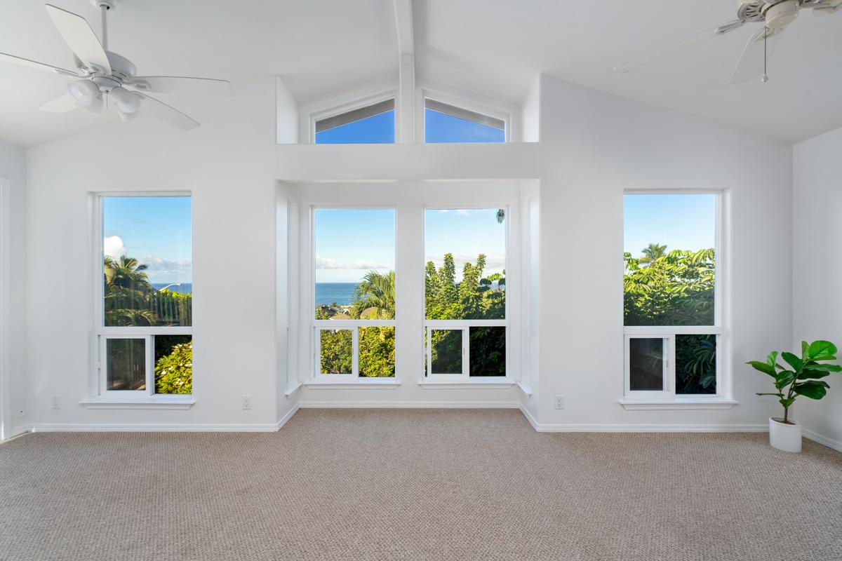 a view of an empty room with a window and potted plant