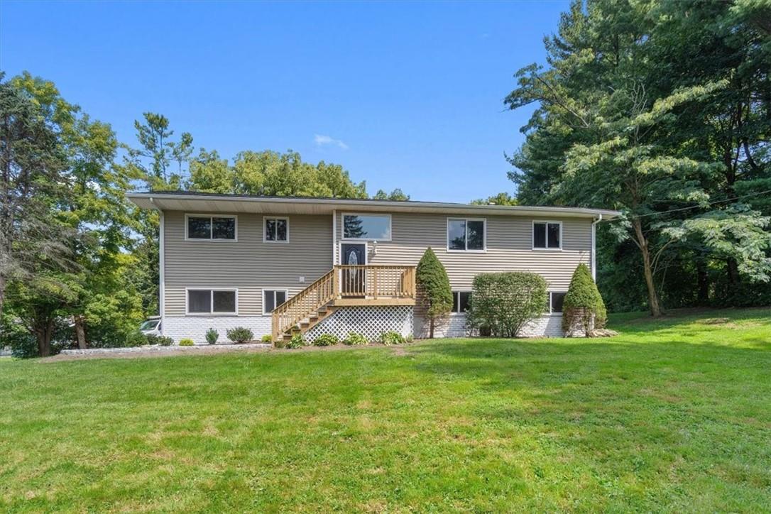 a front view of house with yard and green space