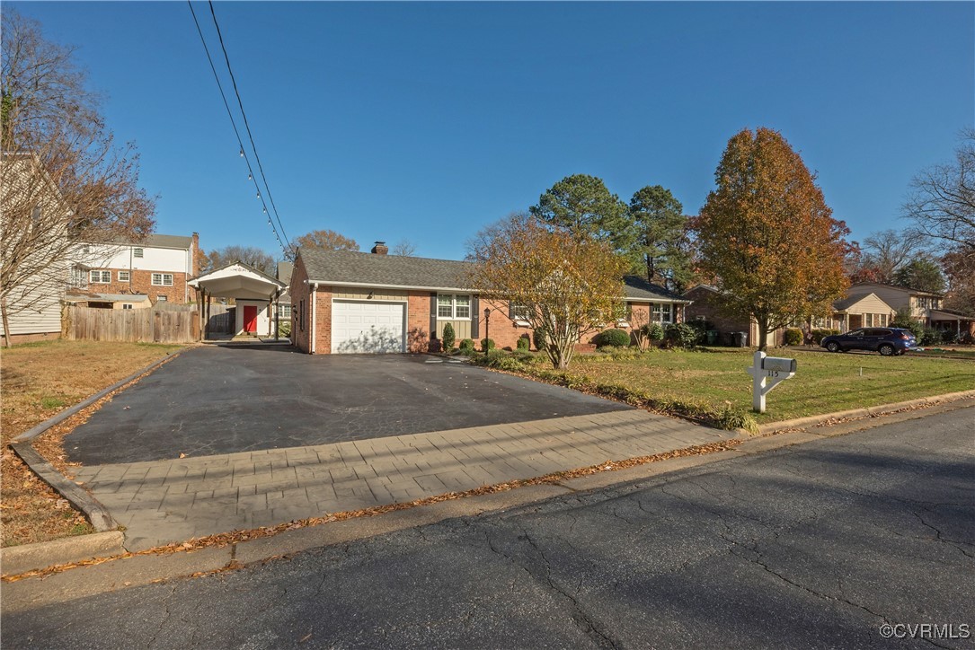 Ranch-style home with a front lawn, a carport, and