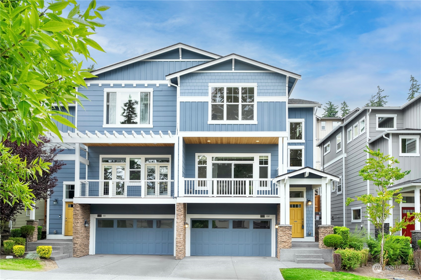 a front view of a residential apartment building with a yard