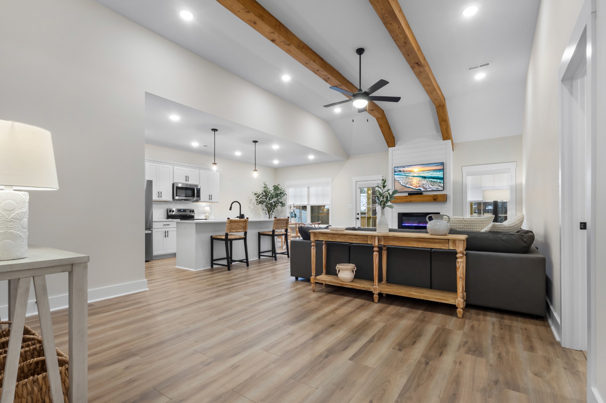 a living room with furniture and kitchen view