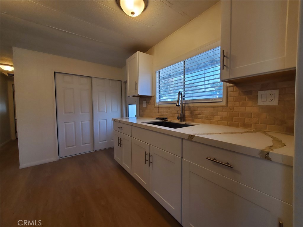 a kitchen with a sink cabinets and a window