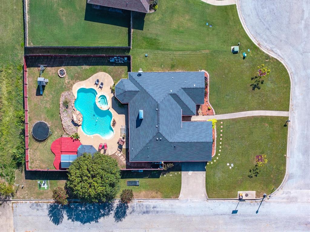 an aerial view of a house with a swimming pool