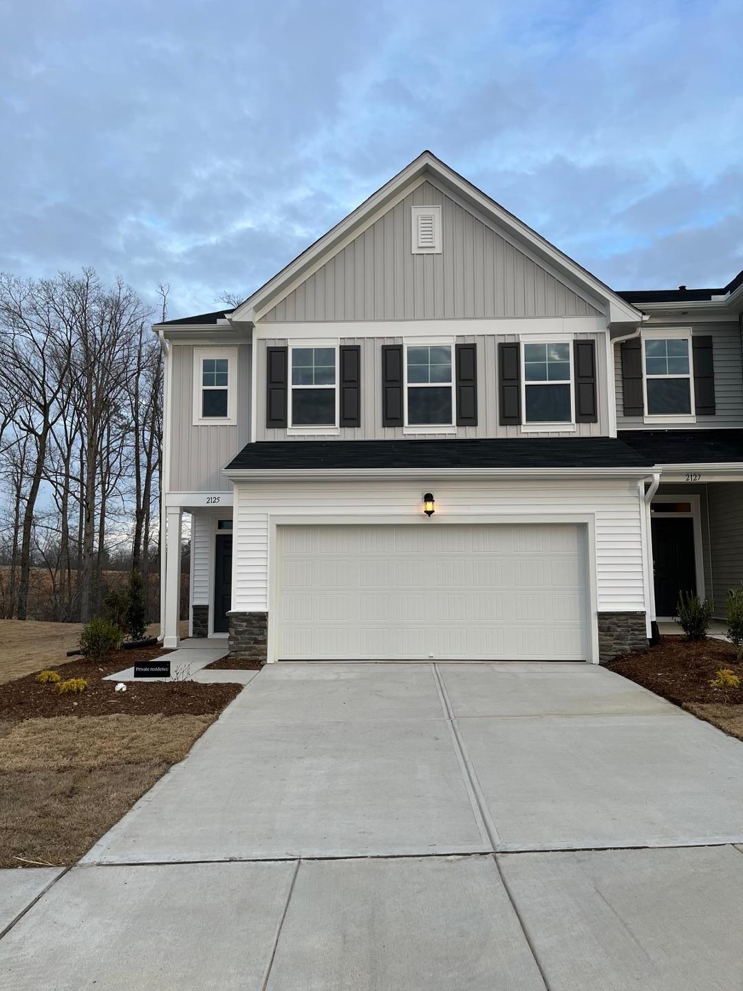 a front view of a house with garage