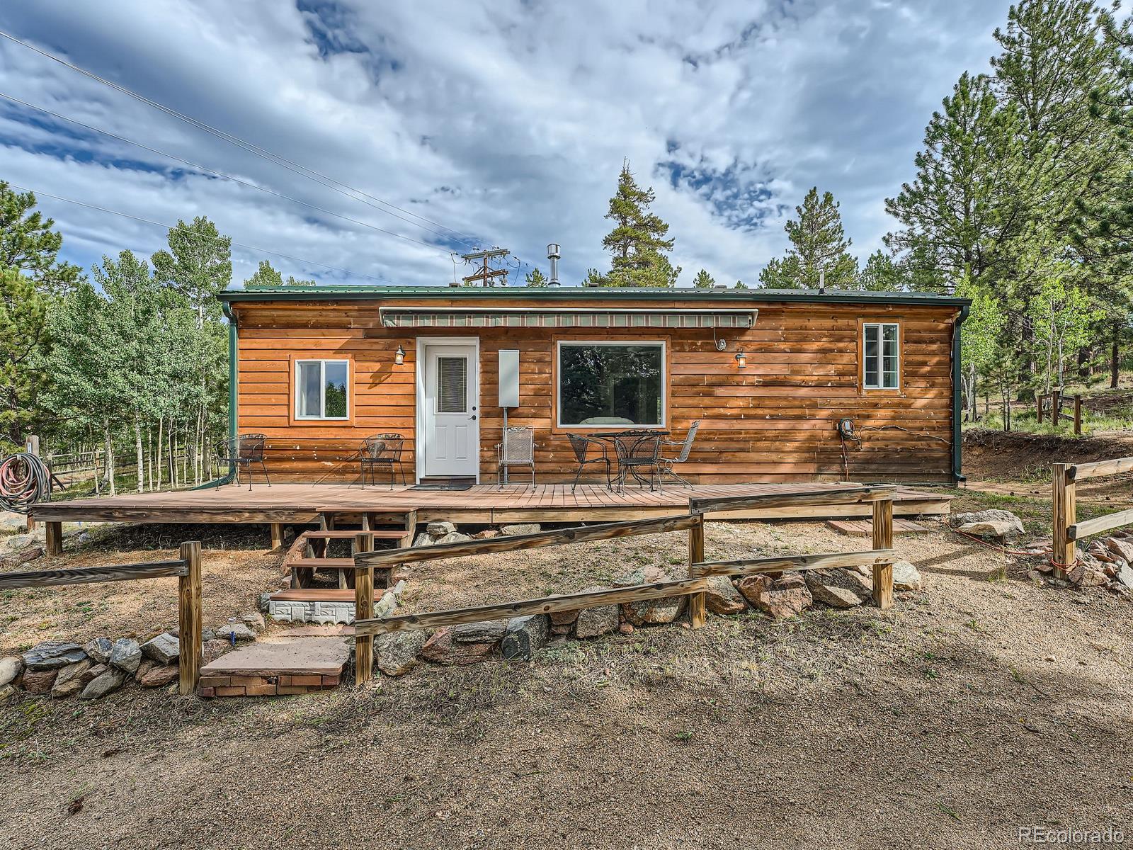 a view of house with backyard and seating area