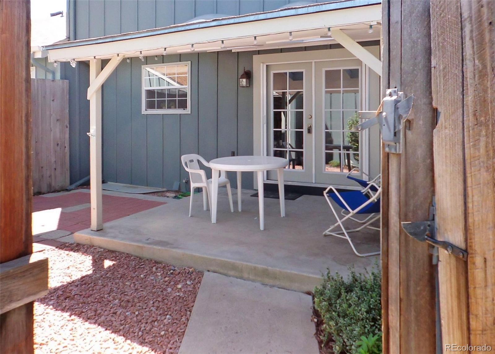 a view of a patio with table and chairs and potted plants