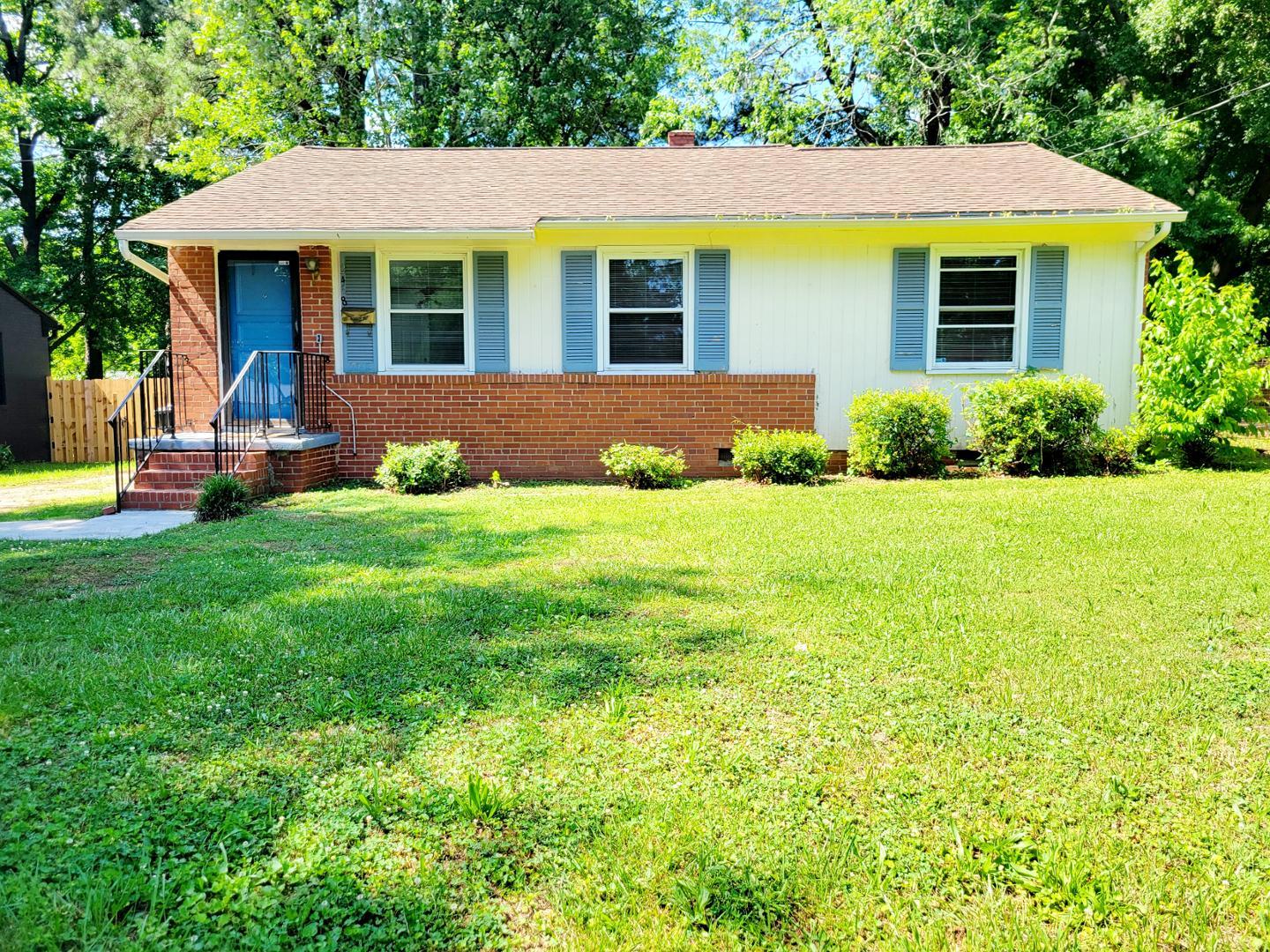 a view of a house with a backyard and sitting area