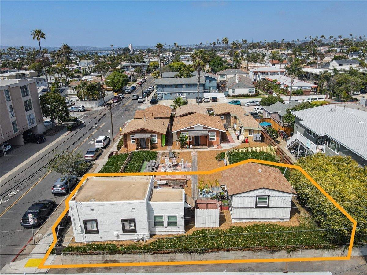 an aerial view of residential houses with yard