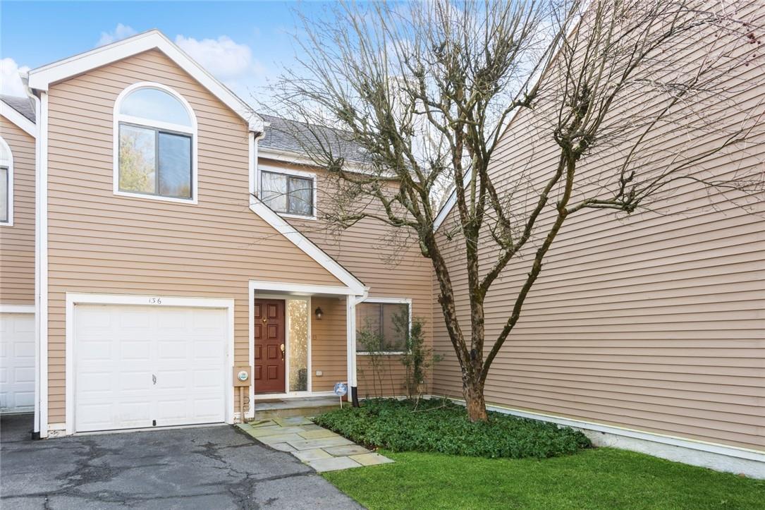 View of front of property with a 1 car garage