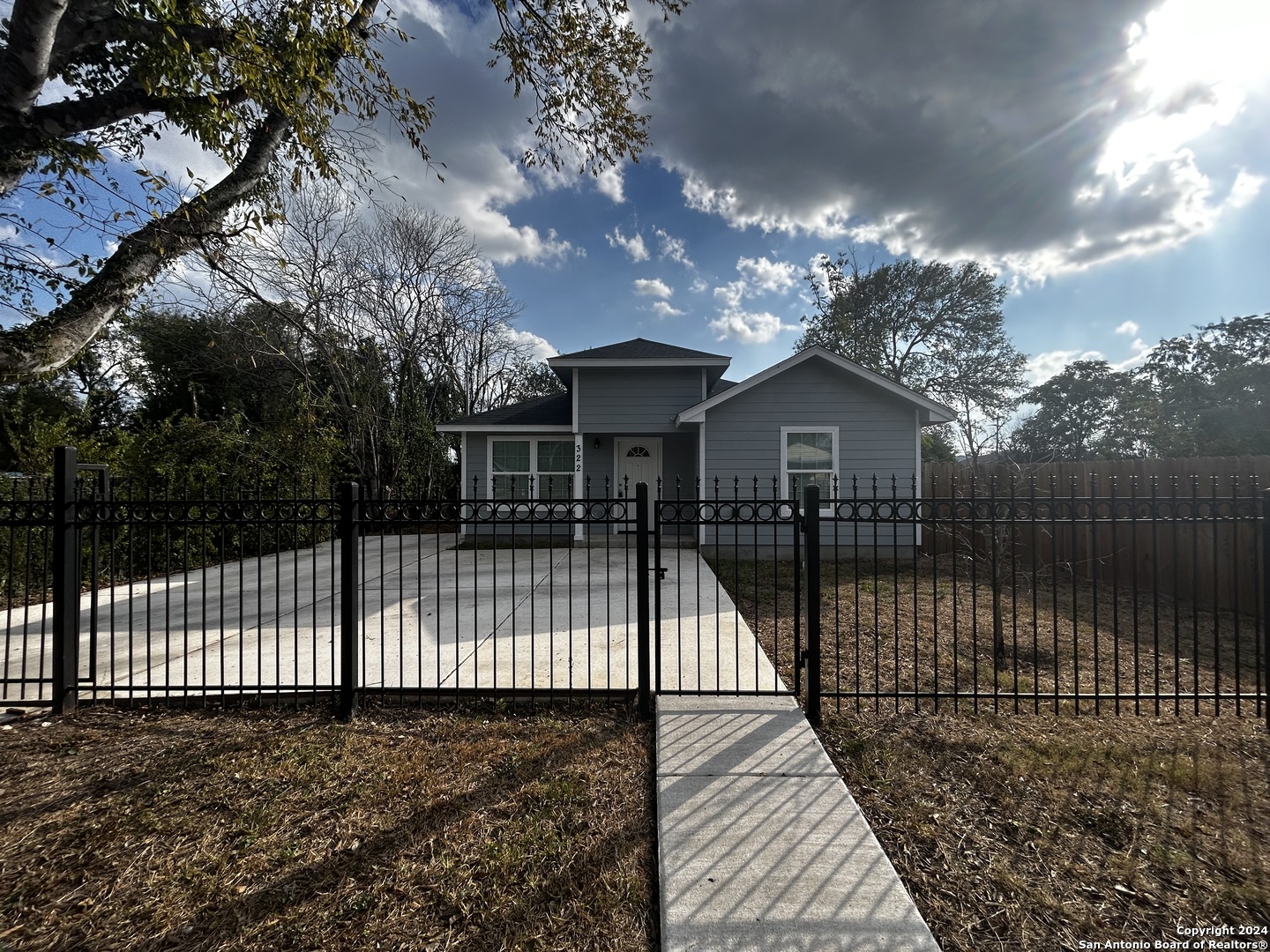 a view of house with a iron gate