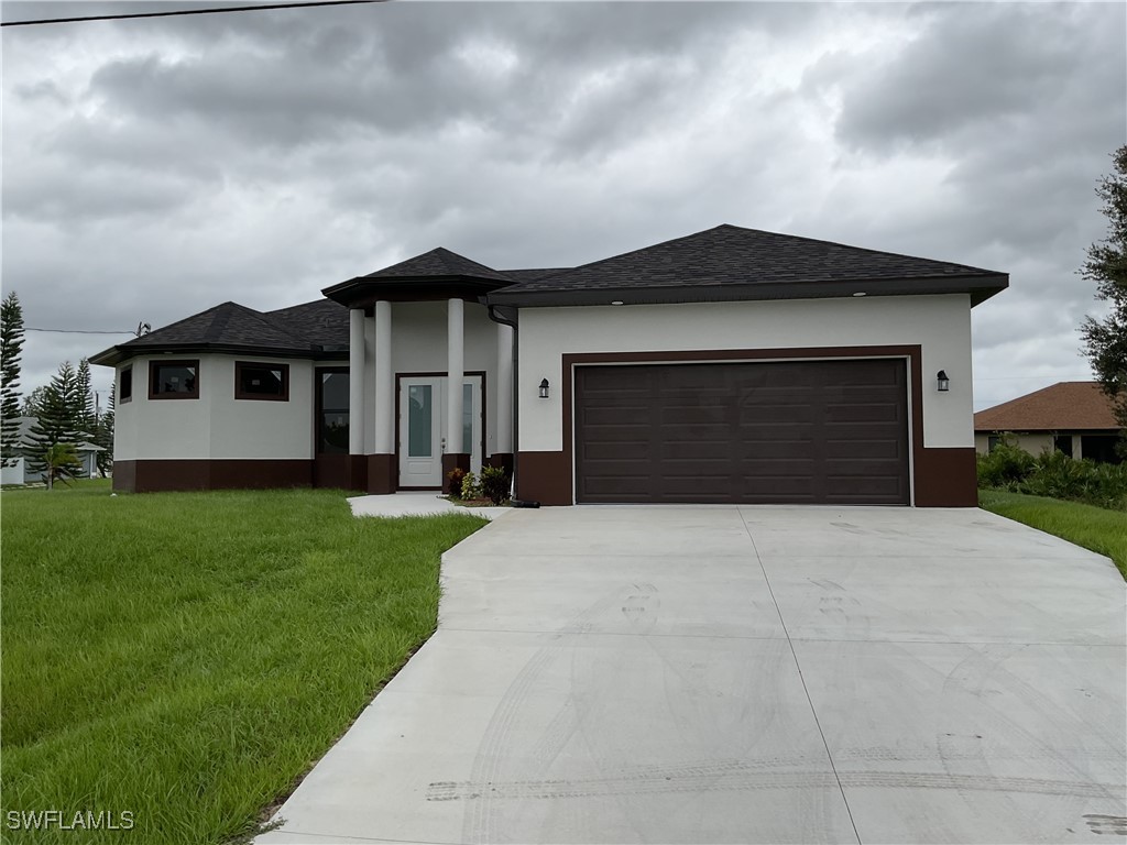 a front view of a house with a yard and garage