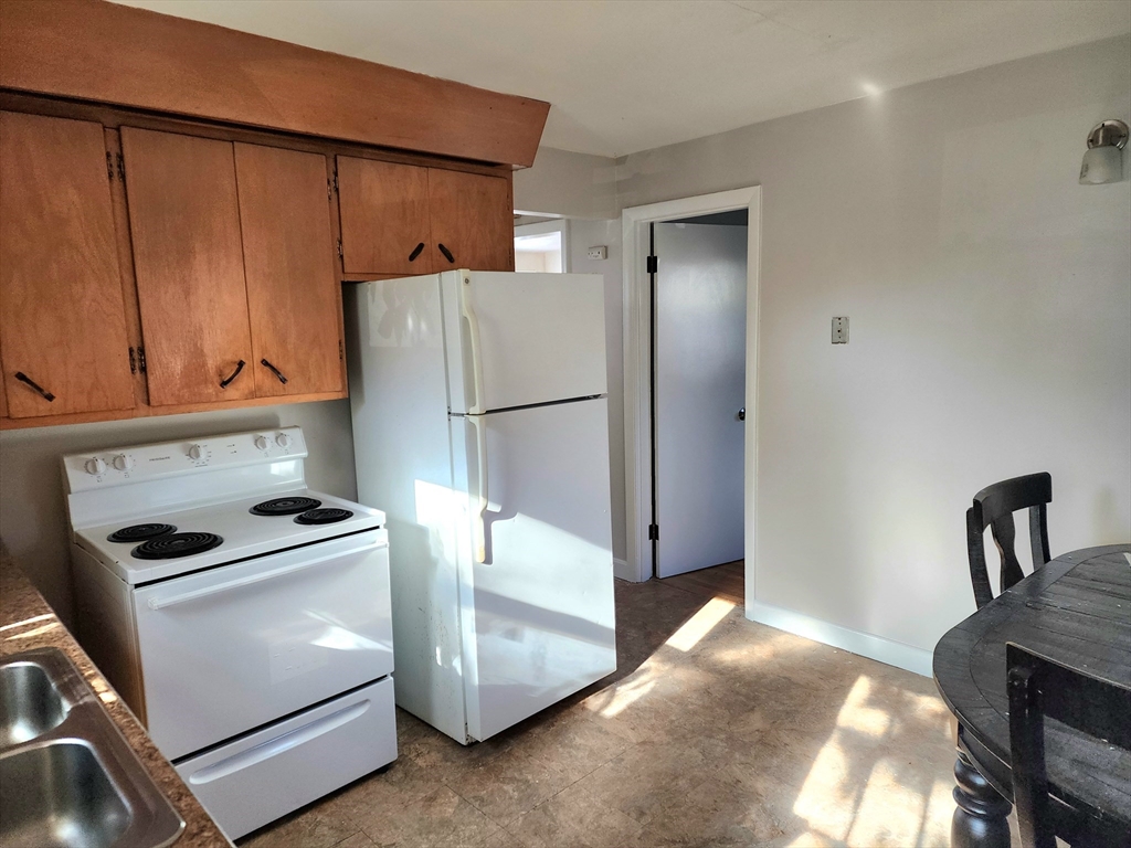 a kitchen with a refrigerator and a stove