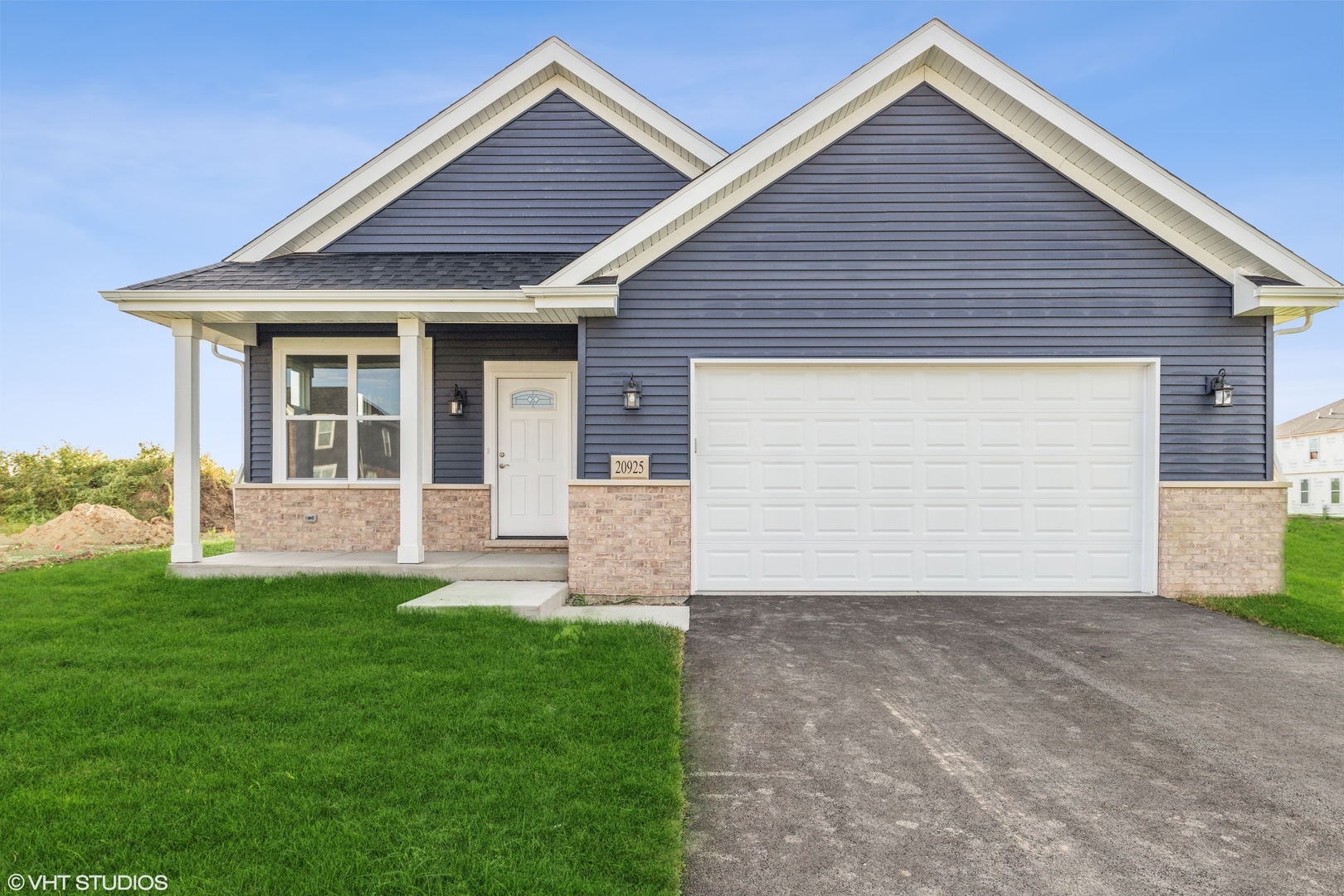 a front view of house with yard and garage