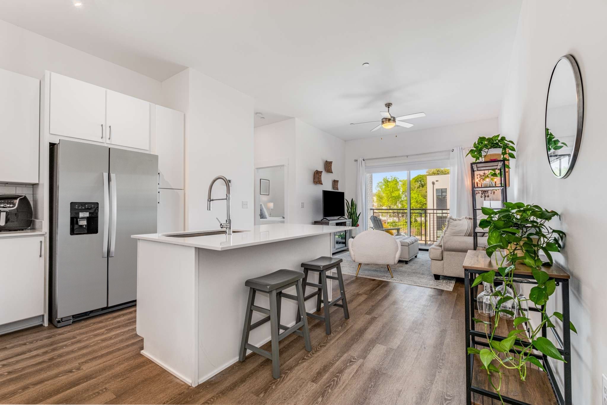 a kitchen with sink refrigerator and window