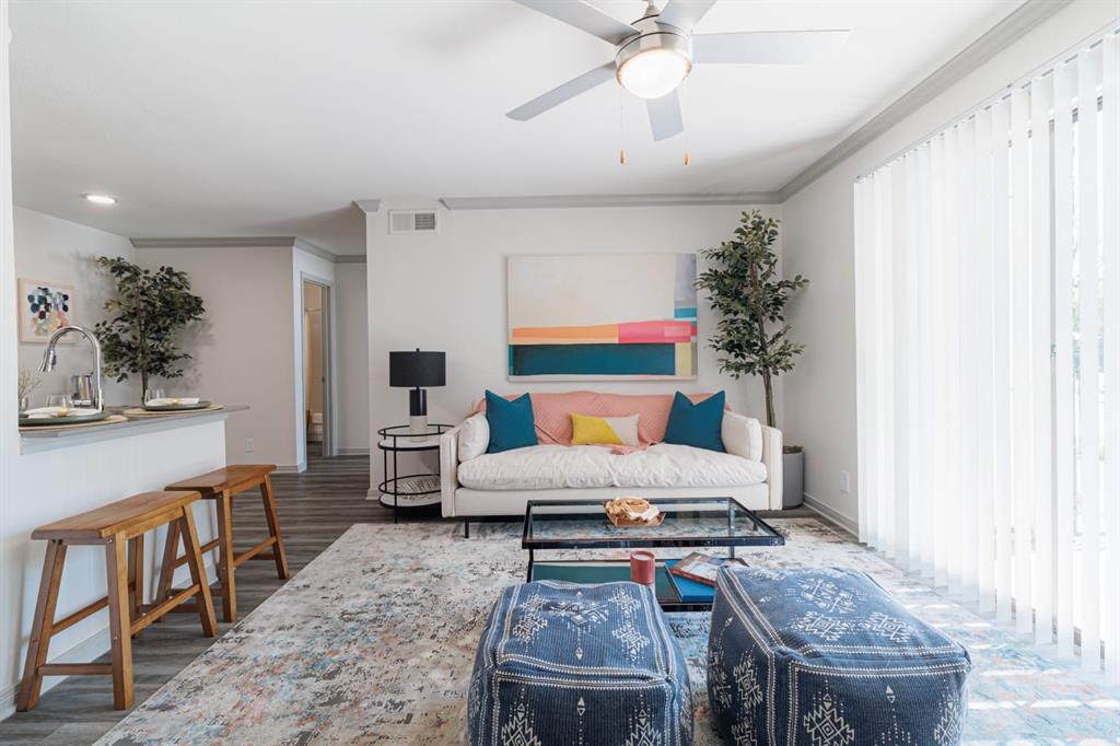 a living room with furniture and a chandelier