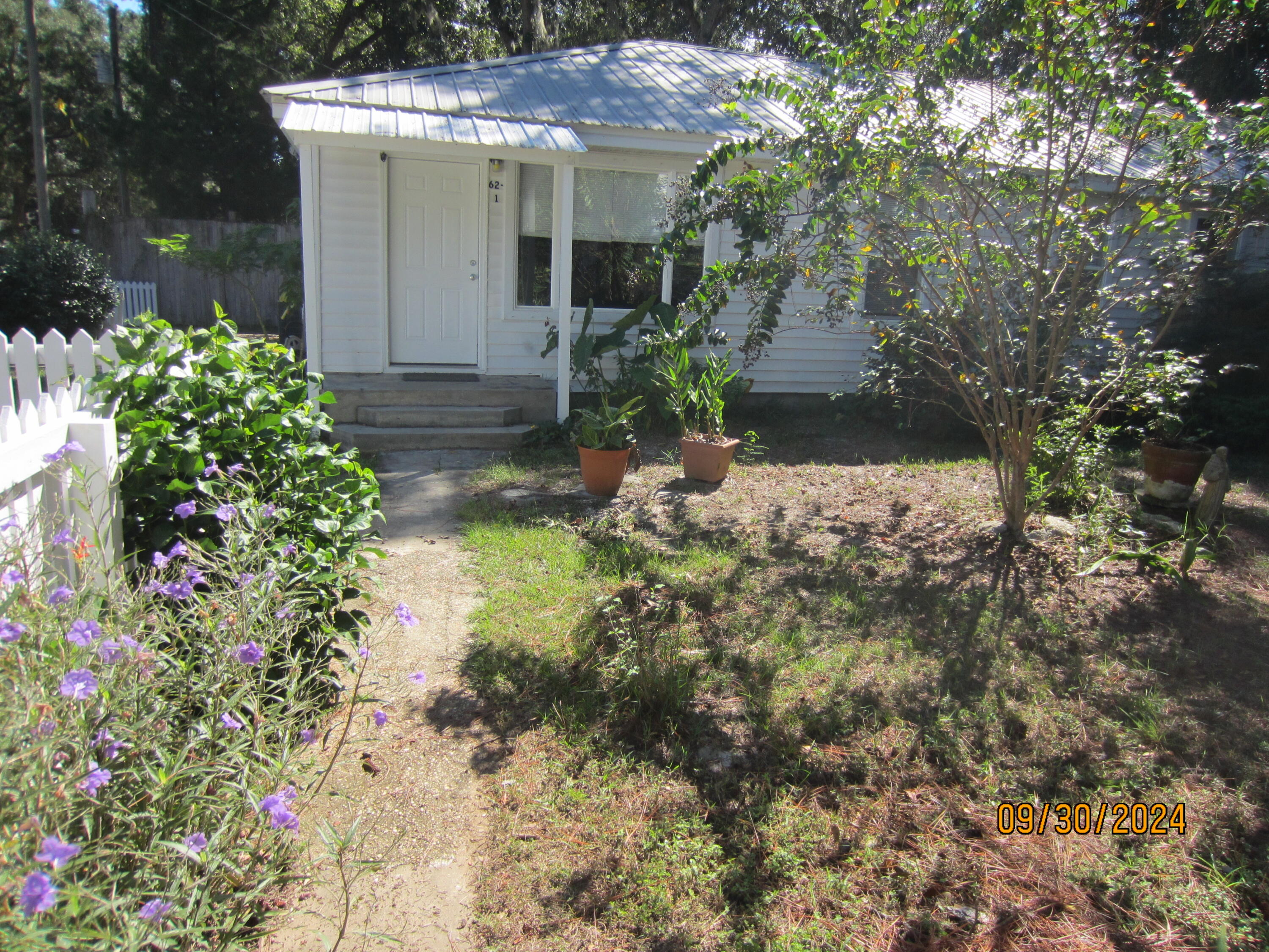 a view of a house with a yard and garden