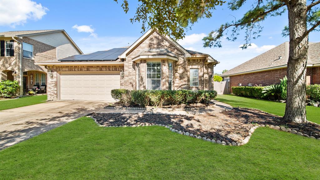 a view of a big house with a big yard and potted plants