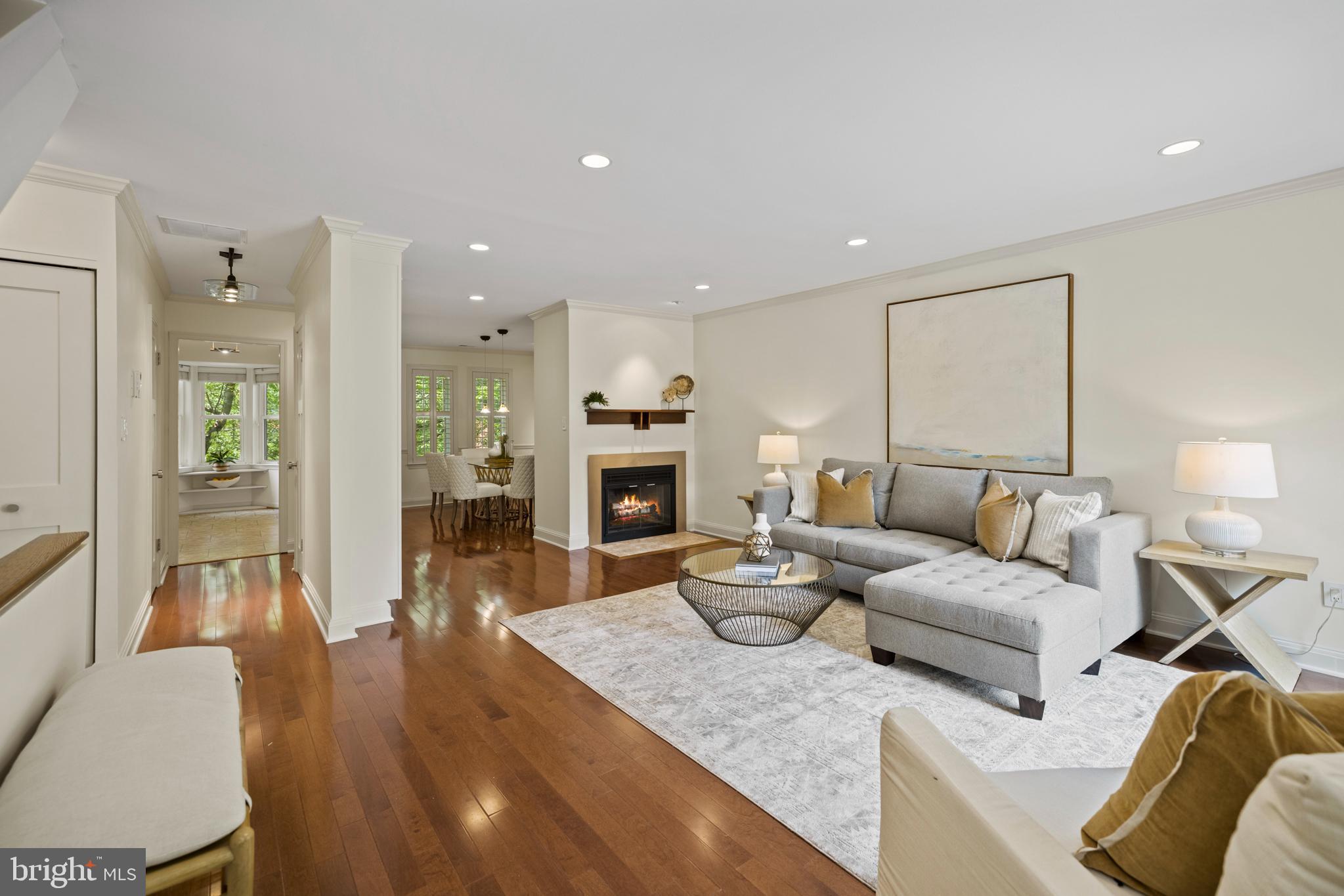 a living room with fireplace furniture and a wooden floor