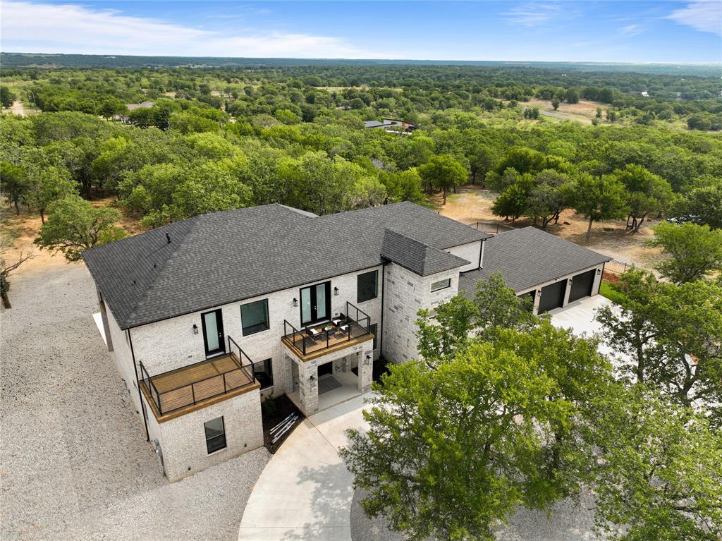 an aerial view of a house with a yard