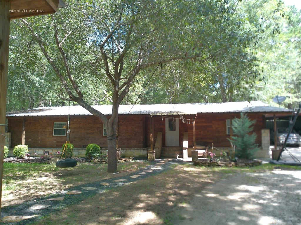 a view of a house with yard and tree s