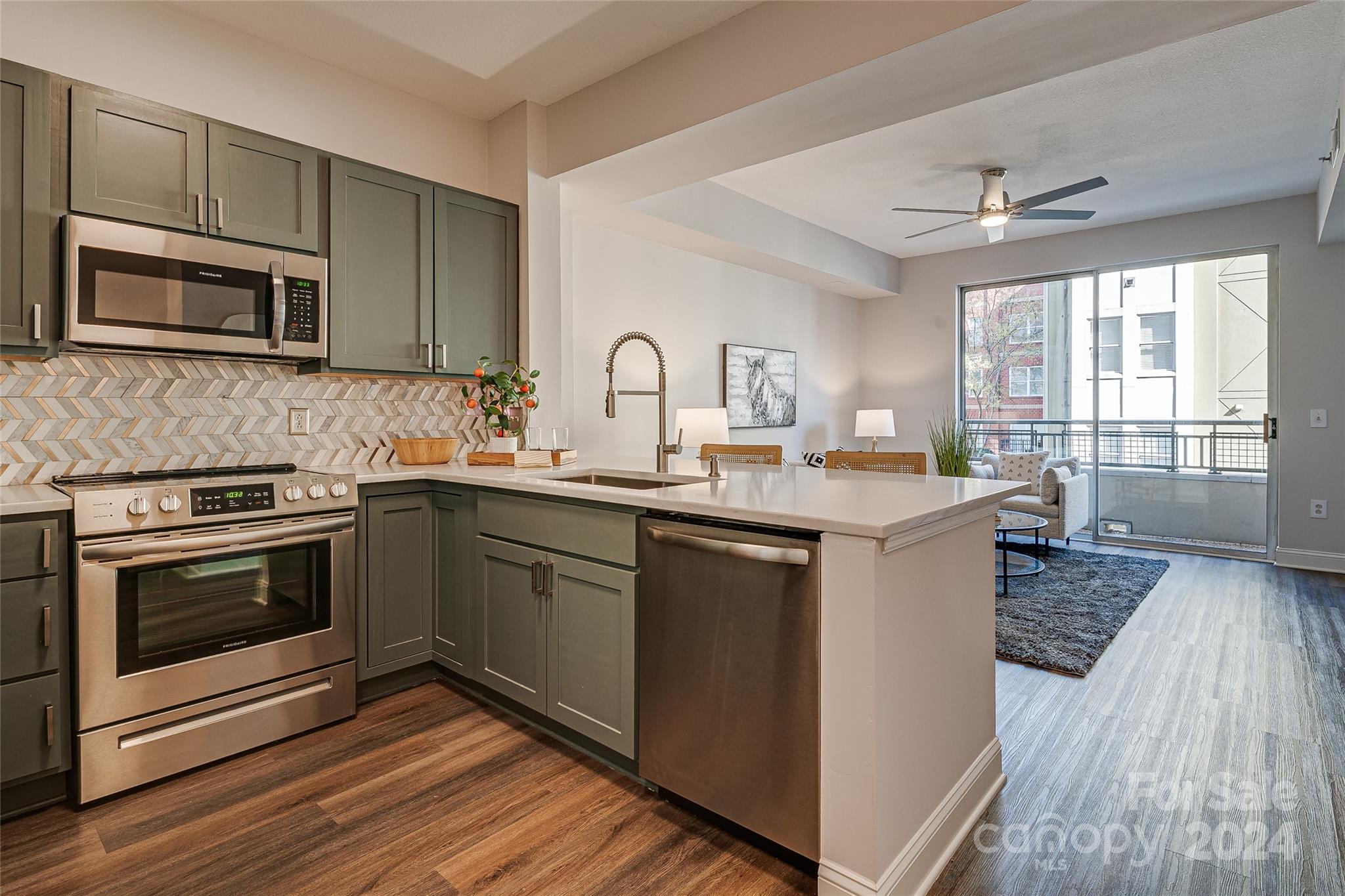 a kitchen with a sink stove and microwave