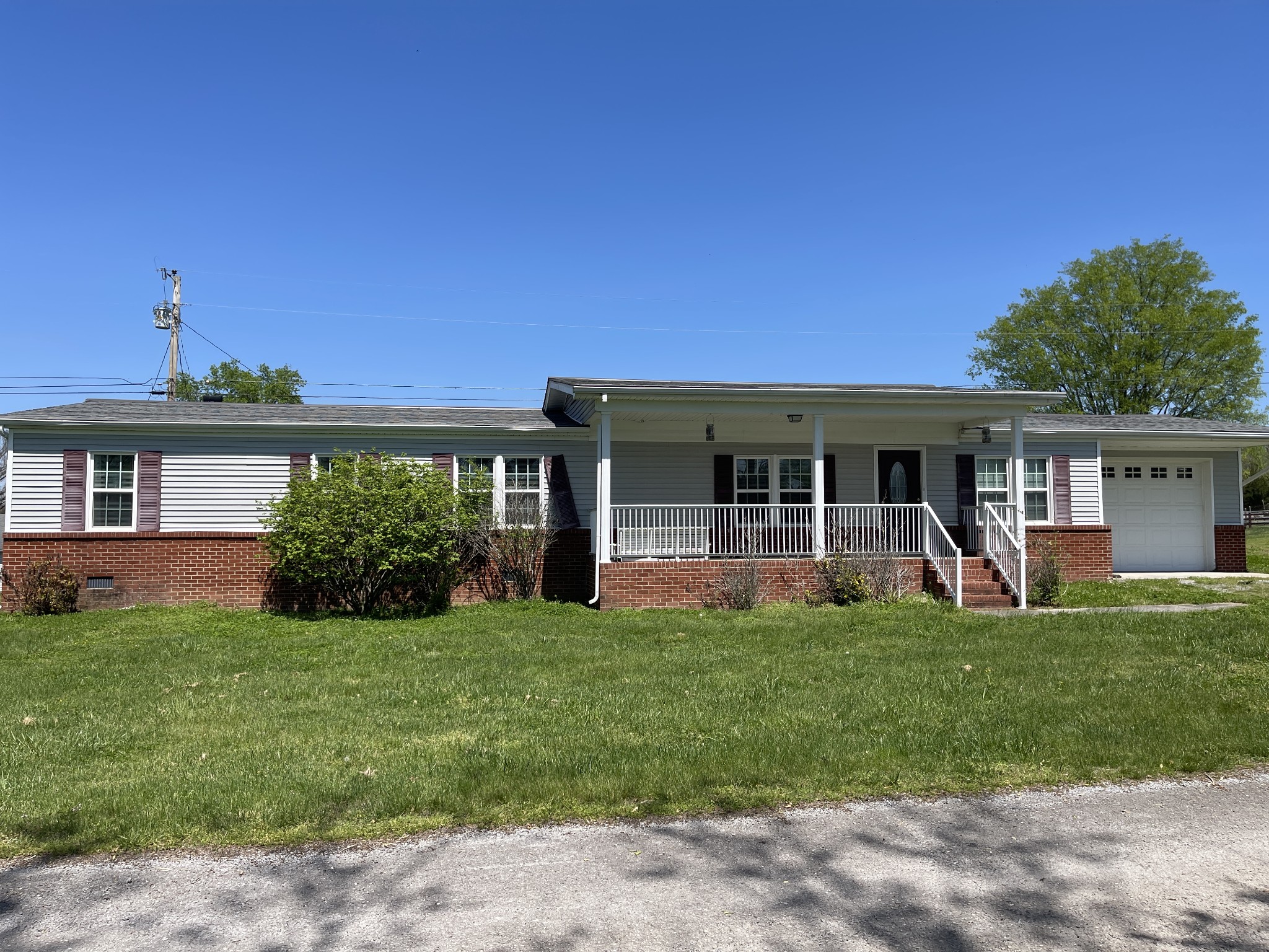 a front view of a house with a yard and porch