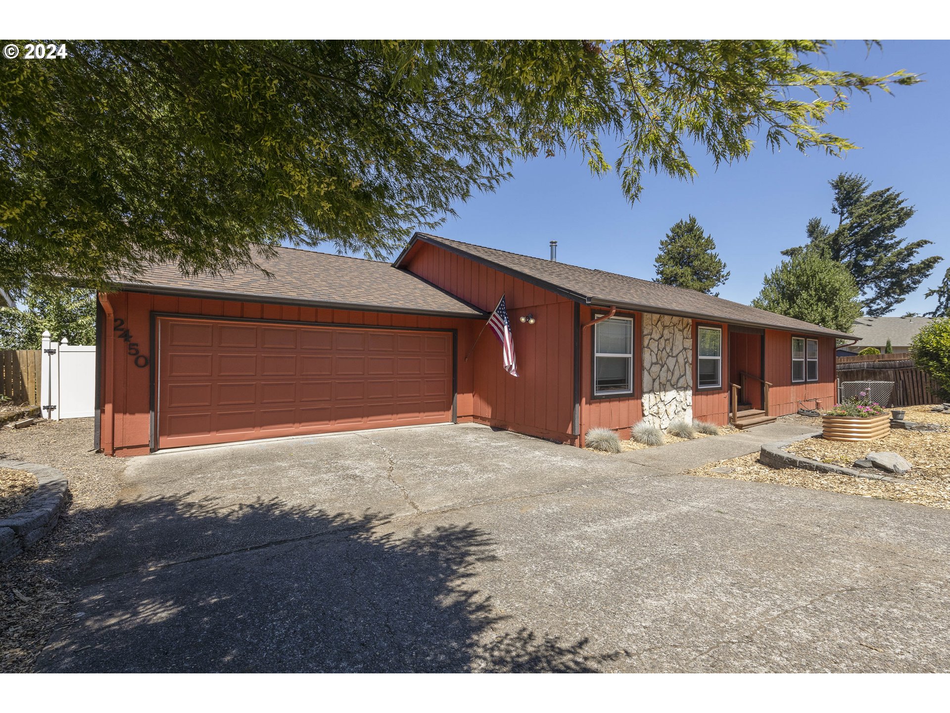 a front view of a house with a yard and parking space